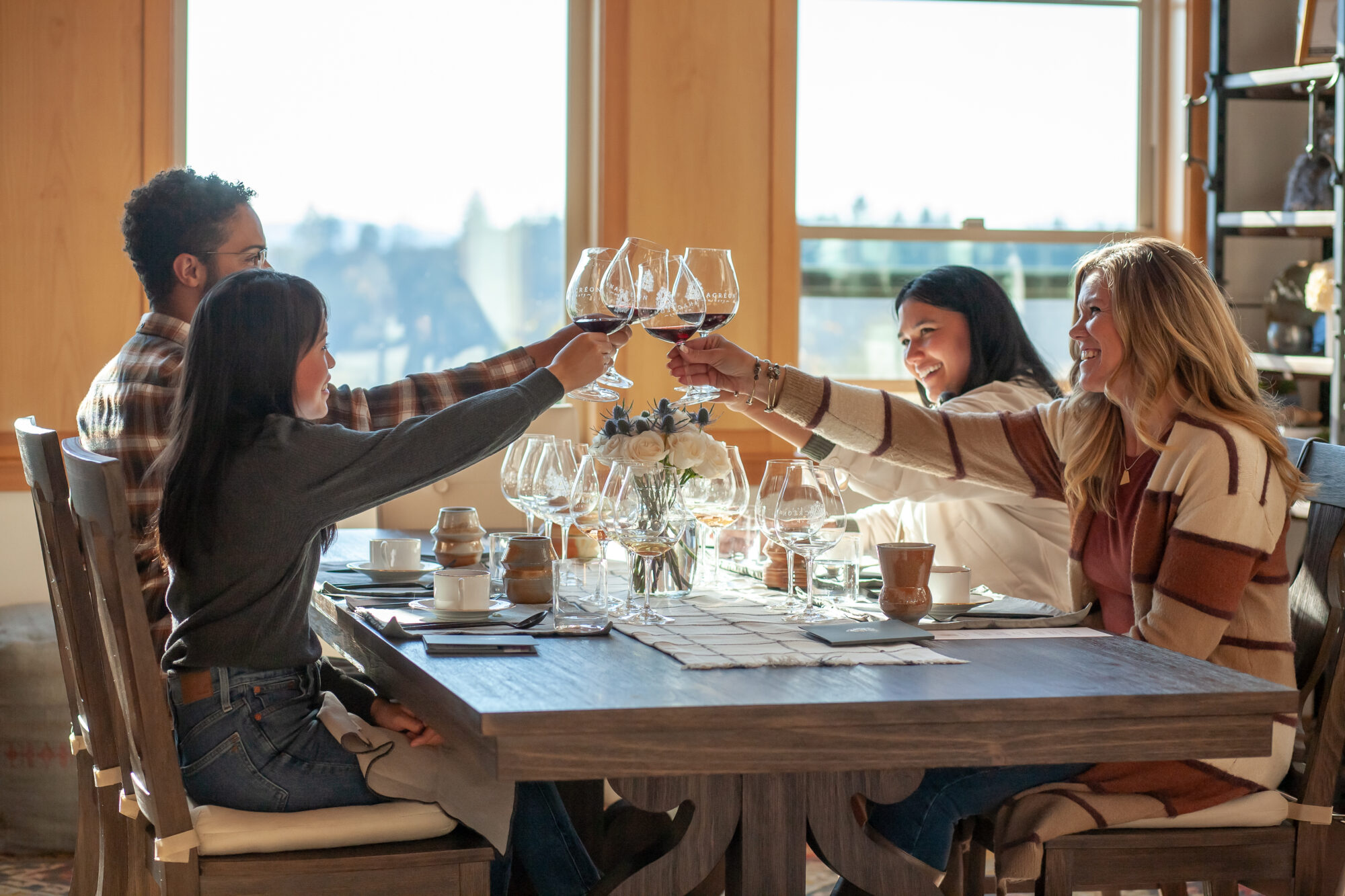 A group raising their glasses to a chef prepared meal.